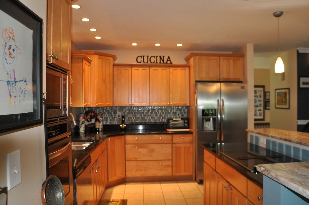 174 Chace Hill Road Sterling, MA 01564 - Photo 6 of 30 a kitchen with stainless steel appliances granite countertop a sink a stove and a refrigerator