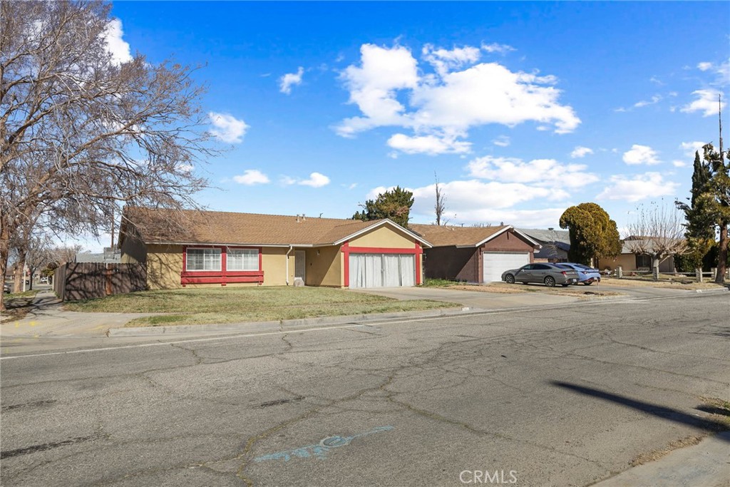 1101 East Lingard Street Lancaster, CA 93535 - Photo 1 of 1 a front view of a house with a yard and garage