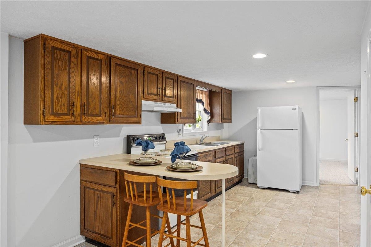 9508 Koontz Corner Road Harrisonburg, VA 22802 - Photo 34 of 55 a kitchen with a sink cabinets and refrigerator