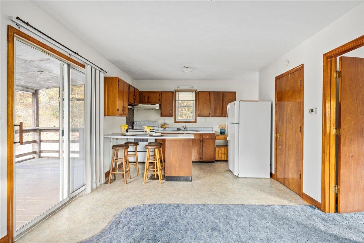 9508 Koontz Corner Road Harrisonburg, VA 22802 - Photo 43 of 55 a kitchen with stainless steel appliances granite countertop a refrigerator and a stove top oven