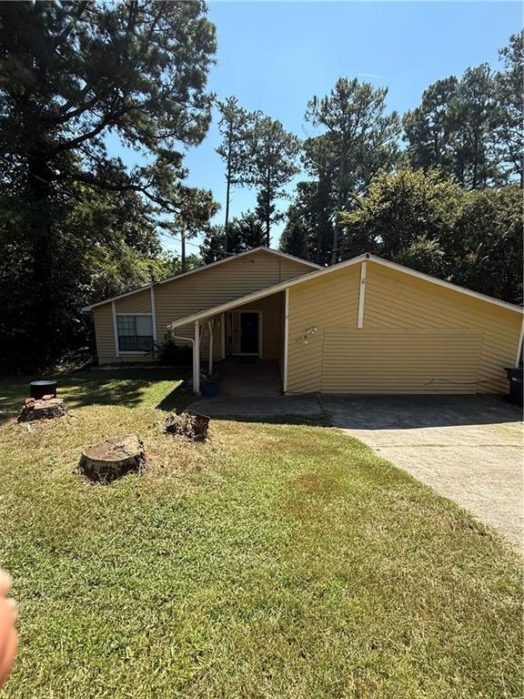 5016 Comanche Court Northwest Lilburn, GA 30047 - Photo 13 of 13 a backyard of a house with table and chairs