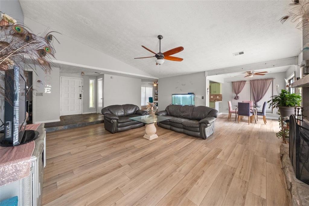 5016 Comanche Court Northwest Lilburn, GA 30047 - Photo 2 of 13 a living room with furniture and a wooden floor