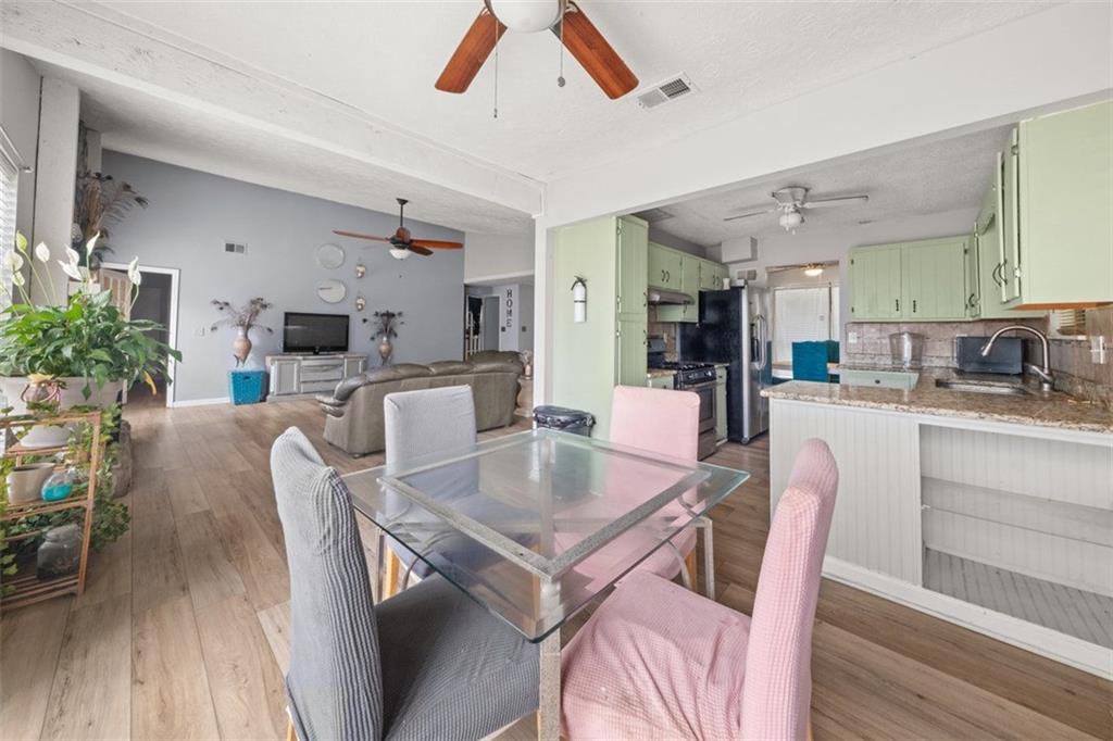 5016 Comanche Court Northwest Lilburn, GA 30047 - Photo 3 of 13 a dining room with furniture and wooden floor