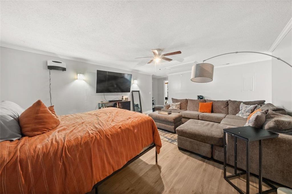 5016 Comanche Court Northwest Lilburn, GA 30047 - Photo 10 of 13 a bedroom with furniture and a flat screen tv