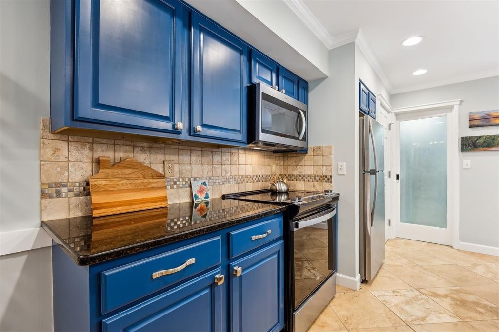 3033 Sea Marsh Road Fernandina Beach, FL 32034 - Photo 10 of 37 a kitchen with stainless steel appliances granite countertop a refrigerator and a stove top oven
