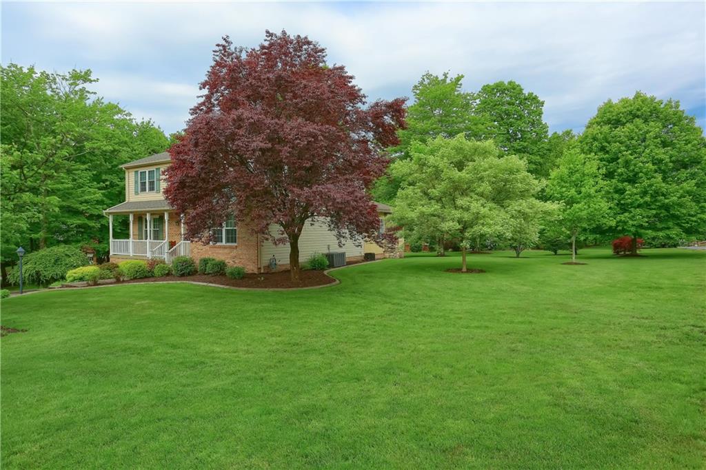 Stunning corner lot home site with full mature foliage throughout.  