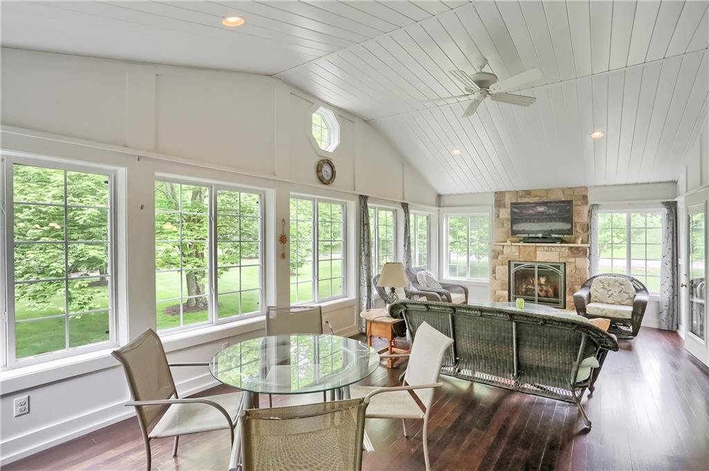 233 Foxglove Road Baden, PA 15005 - Photo 12 of 25 Wow, the 3 season room is striking with vaulted ceiling, fireplace and hardwood floor.