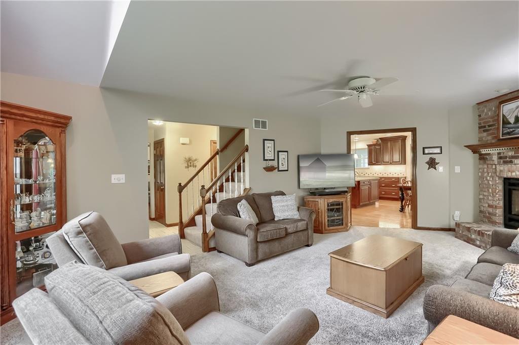 233 Foxglove Road Baden, PA 15005 - Photo 15 of 25 A spacious family room features a brick fireplace and plush carpeting.