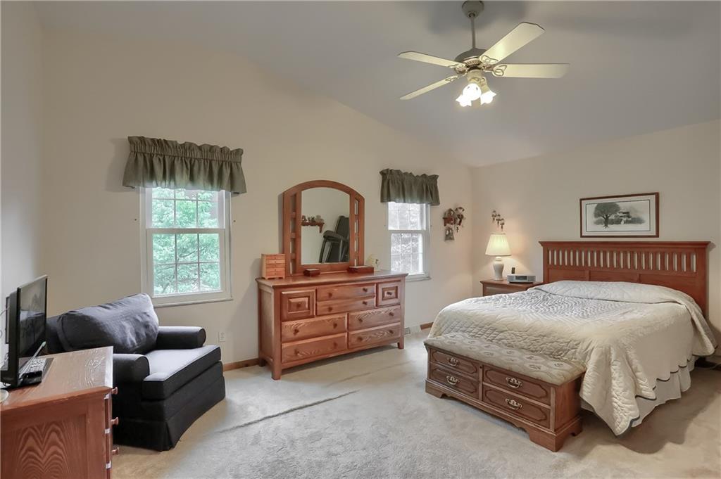 233 Foxglove Road Baden, PA 15005 - Photo 16 of 25 A roomy master bedroom features plush neutral carpet, a vaulted ceiling, bright windows, amazing walk in closet with closet system and a spa like updated private bathroom.