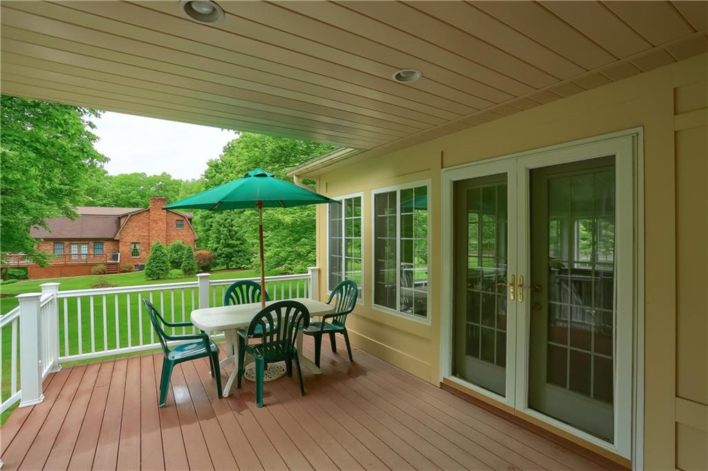 233 Foxglove Road Baden, PA 15005 - Photo 25 of 25 The partially covered composite deck leads to the dining room and the 3 season room. Enjoy the day rain or shine.