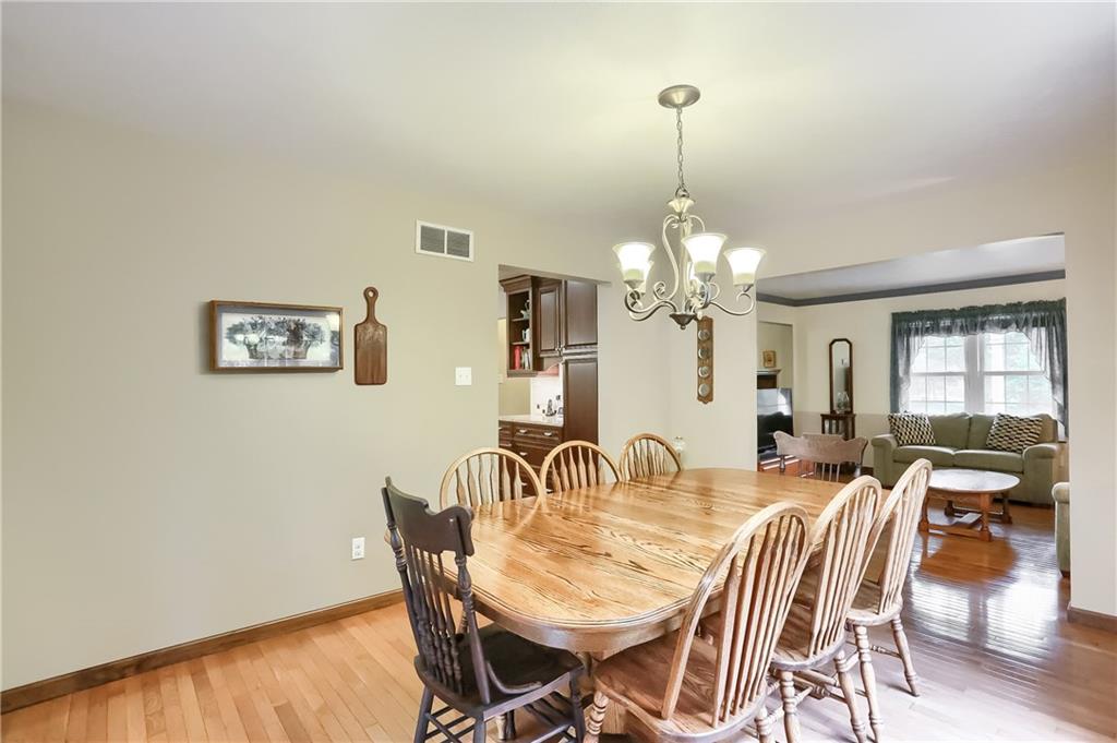 The spacious dining room provides plenty of room for the next dinner party and features French door access to the partially covered, rear composite deck. 
