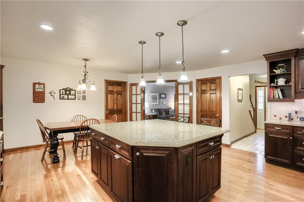 The updated kitchen has endless quartz counter tops, abundant custom cabinetry with under cabinetry lighting, complimentary backsplash and much more.