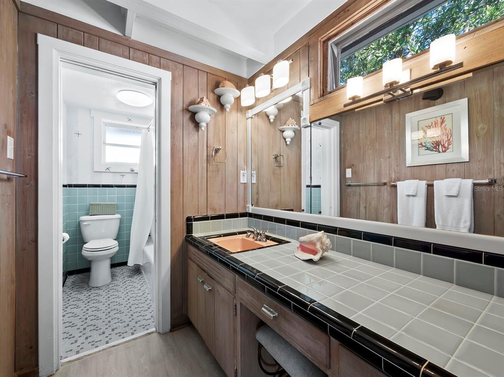 1620 Casey Key Road Nokomis, FL 34275 - Photo 25 of 49 a bathroom with a granite countertop sink a toilet a mirror and shower