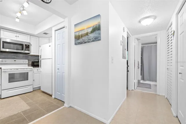 a view of kitchen with stainless steel appliances cabinets and a window