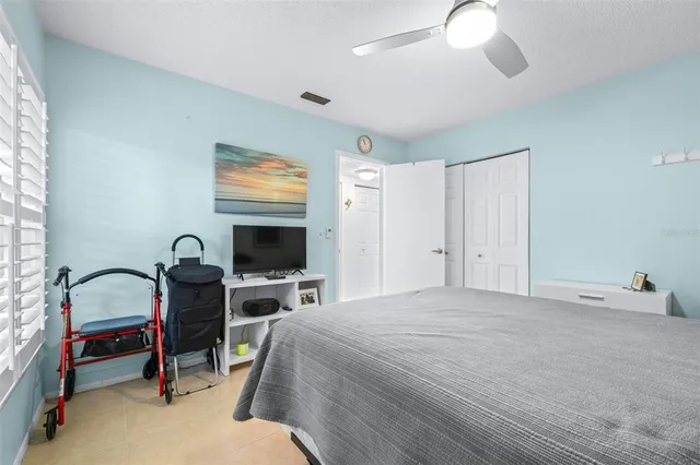 a bedroom with bed and a flat screen tv