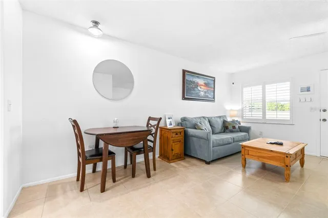 a living room with furniture a window and a work place