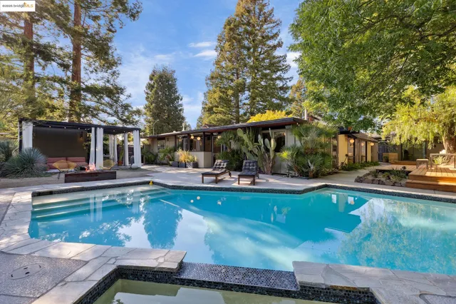 a view of a swimming pool with chair and tables
