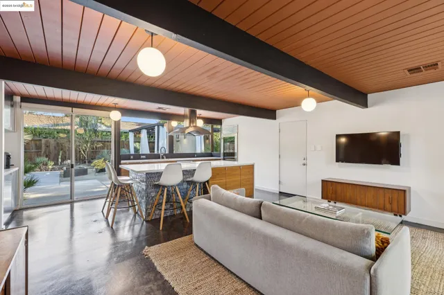 a large white kitchen with a large window