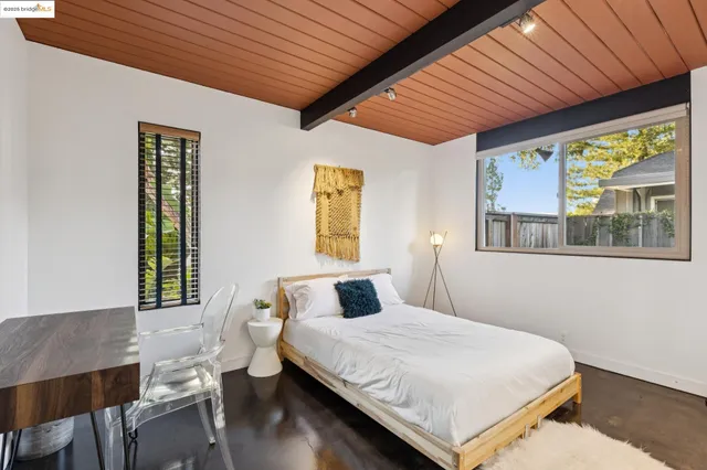 a view of a hallway with a couch and chandelier