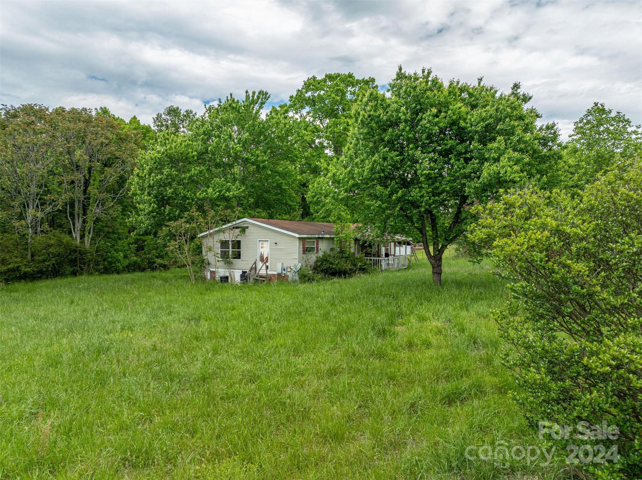 733 Cedar Grove Church Road Vale, NC 28168 - Photo 3 of 9 a house with green field in front of it