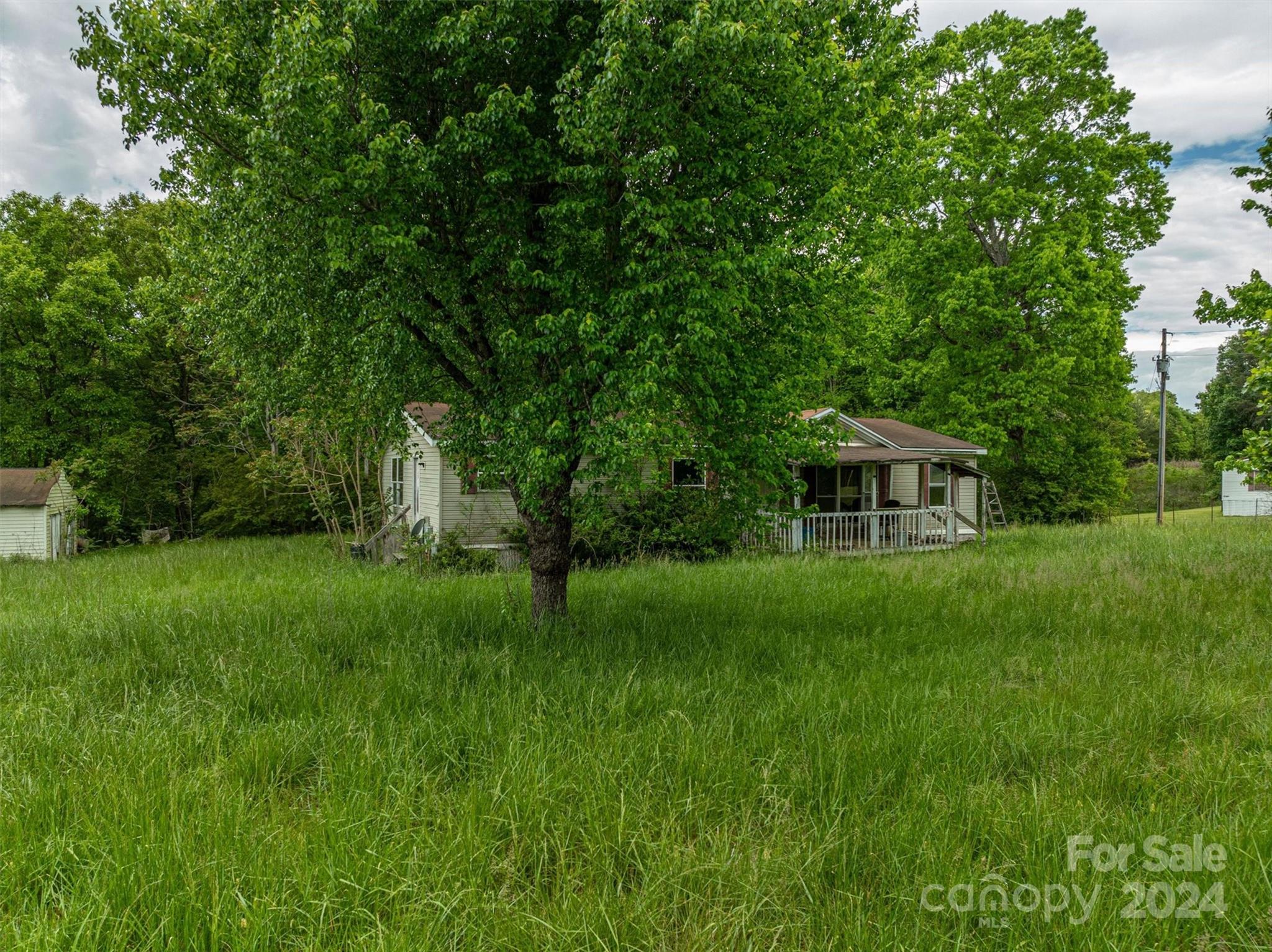 733 Cedar Grove Church Road Vale, NC 28168 - Photo 7 of 9 a view of a garden with a house in the background