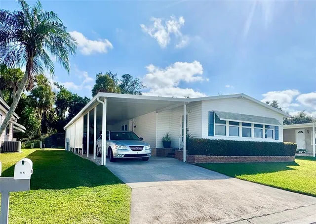 a house view with a sitting space fire pit and outdoor space