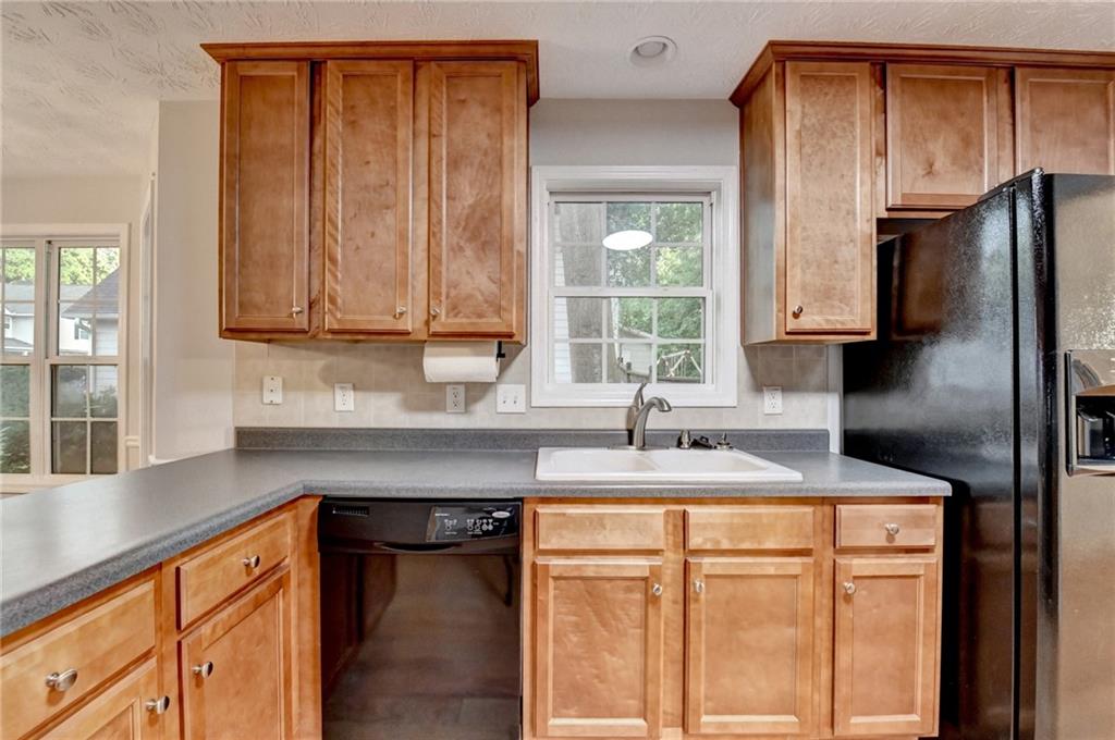 310 Andrew Ridge Drive Jefferson, GA 30549 - Photo 19 of 52 a kitchen with stainless steel appliances granite countertop a sink stove and refrigerator