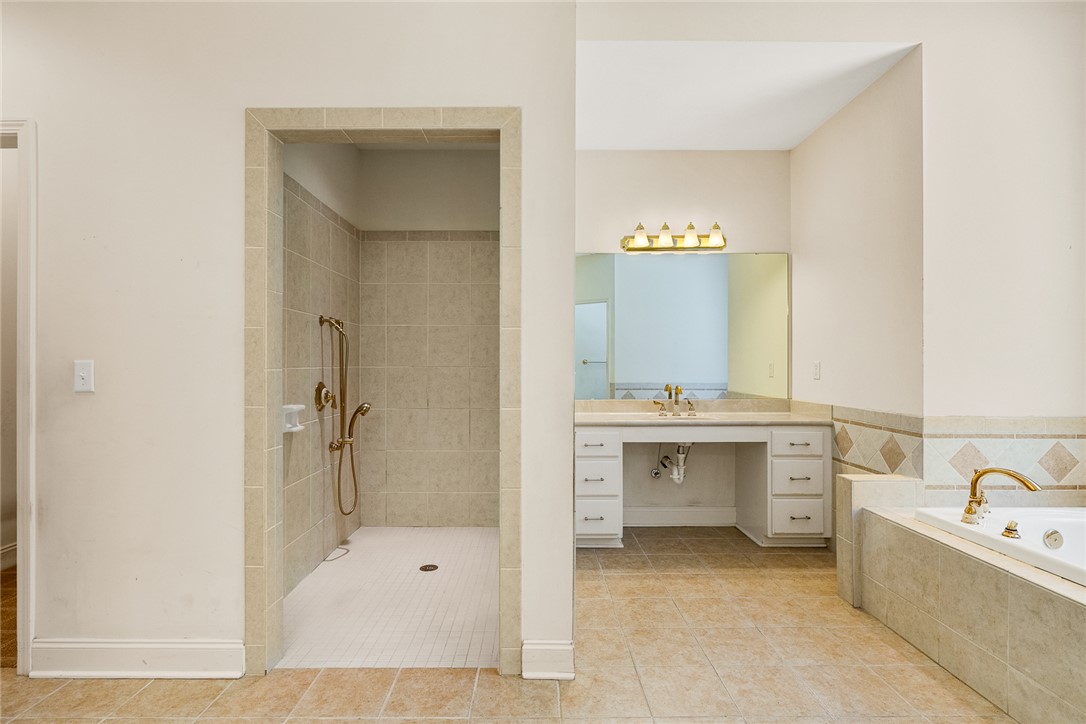 135 Sunset Bay Boulevard Seneca, SC 29672 - Photo 28 of 50 A generously sized primary bathroom showcasing both a tiled walk-in shower and a built-in tub for relaxation.