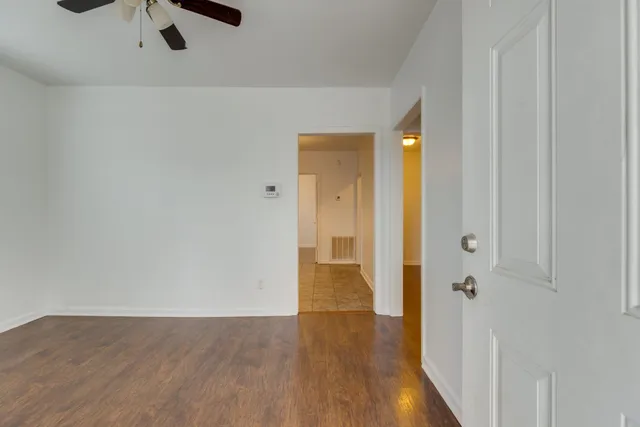 a view of a hallway with wooden floor