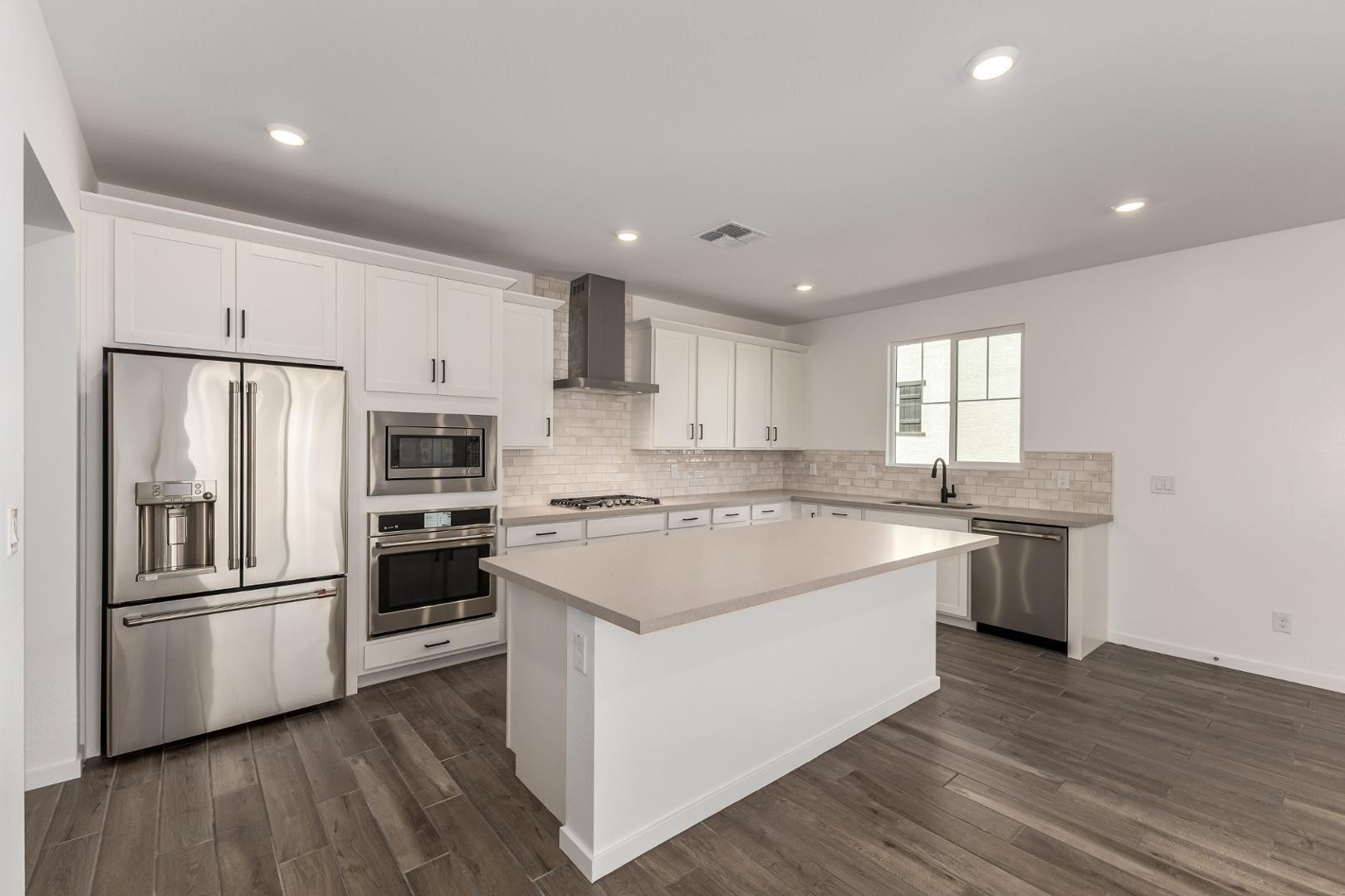 2434 West Maximo Way Phoenix, AZ 85085 - Photo 11 of 35 a kitchen with a refrigerator sink and wooden floor