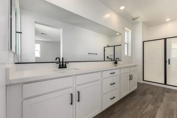 an open kitchen with a sink and a refrigerator