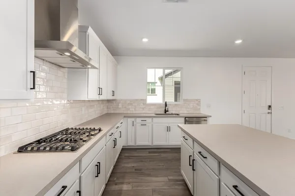 an empty room with a bathroom and a sink