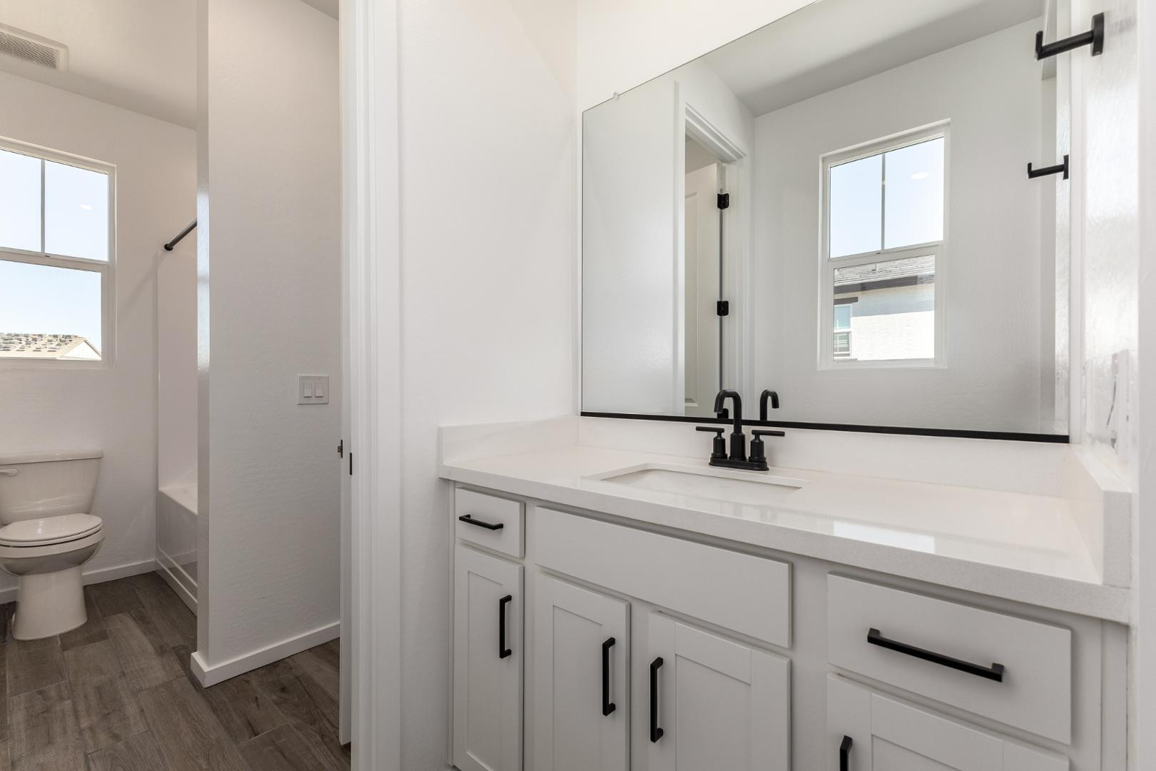 2434 West Maximo Way Phoenix, AZ 85085 - Photo 17 of 35 a bathroom with a sink a toilet and a window