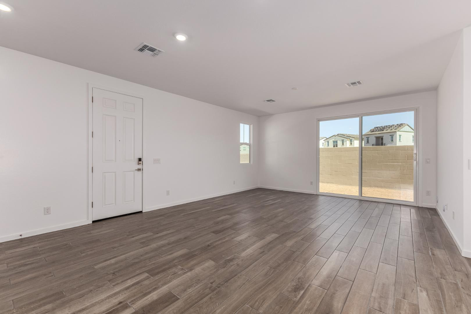 2434 West Maximo Way Phoenix, AZ 85085 - Photo 4 of 35 a view of empty room with wooden floor and fan