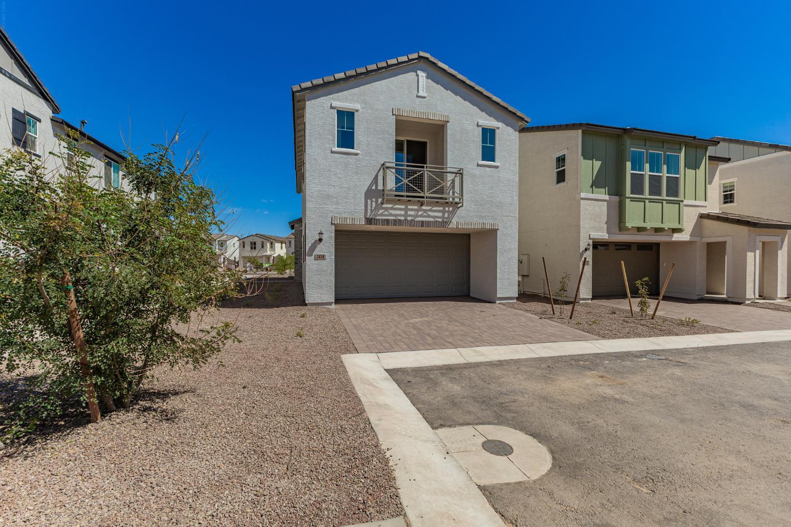 2434 West Maximo Way Phoenix, AZ 85085 - Photo 6 of 35 a view of a house with a yard and garage