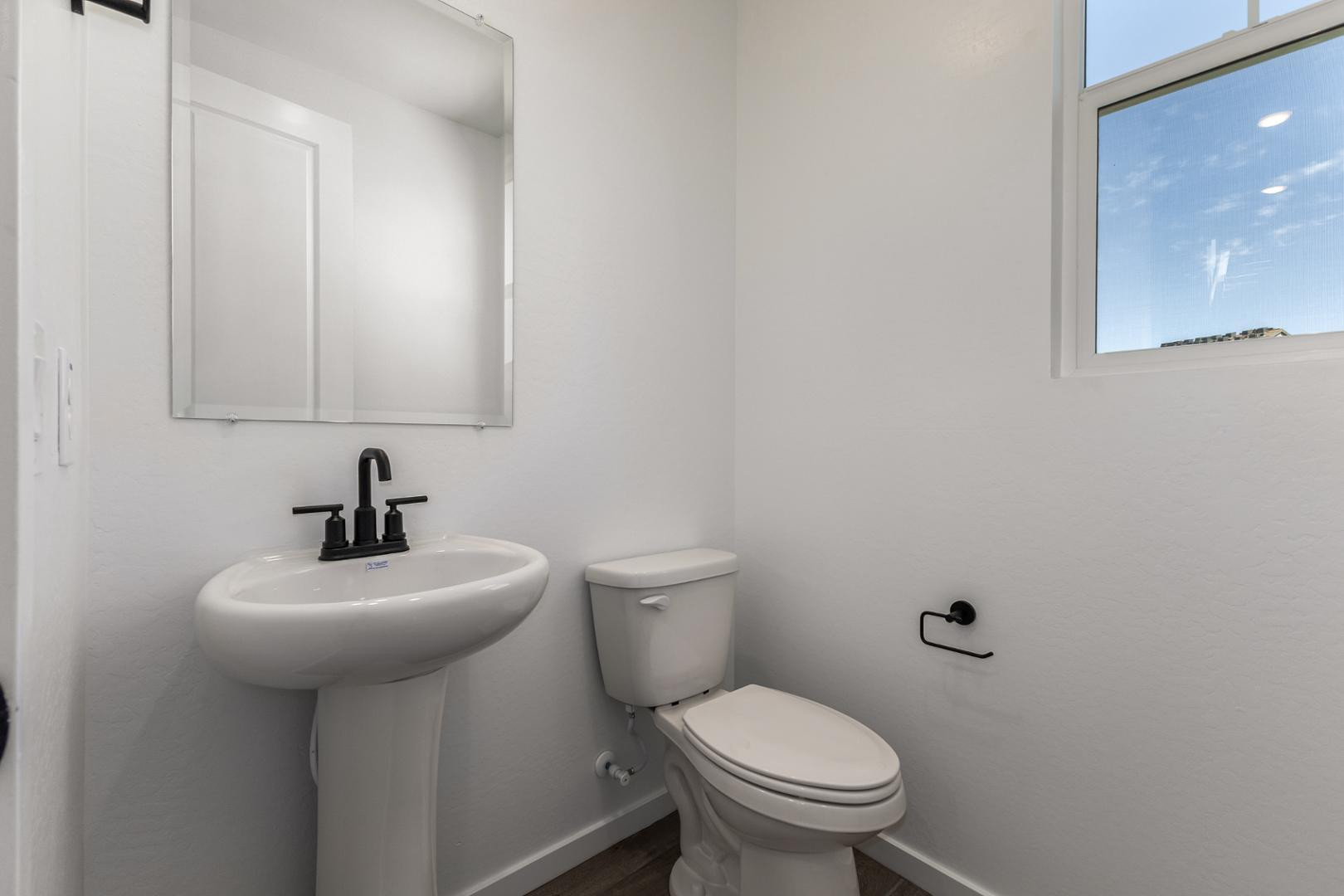 2434 West Maximo Way Phoenix, AZ 85085 - Photo 9 of 35 a bathroom with a toilet sink and mirror