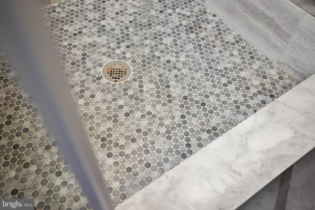 a living room with furniture a wooden floor and a flat screen tv