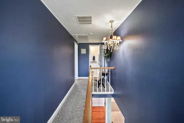 a kitchen with a refrigerator and white cabinets