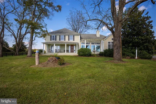 a living room with furniture a rug and wall paintings