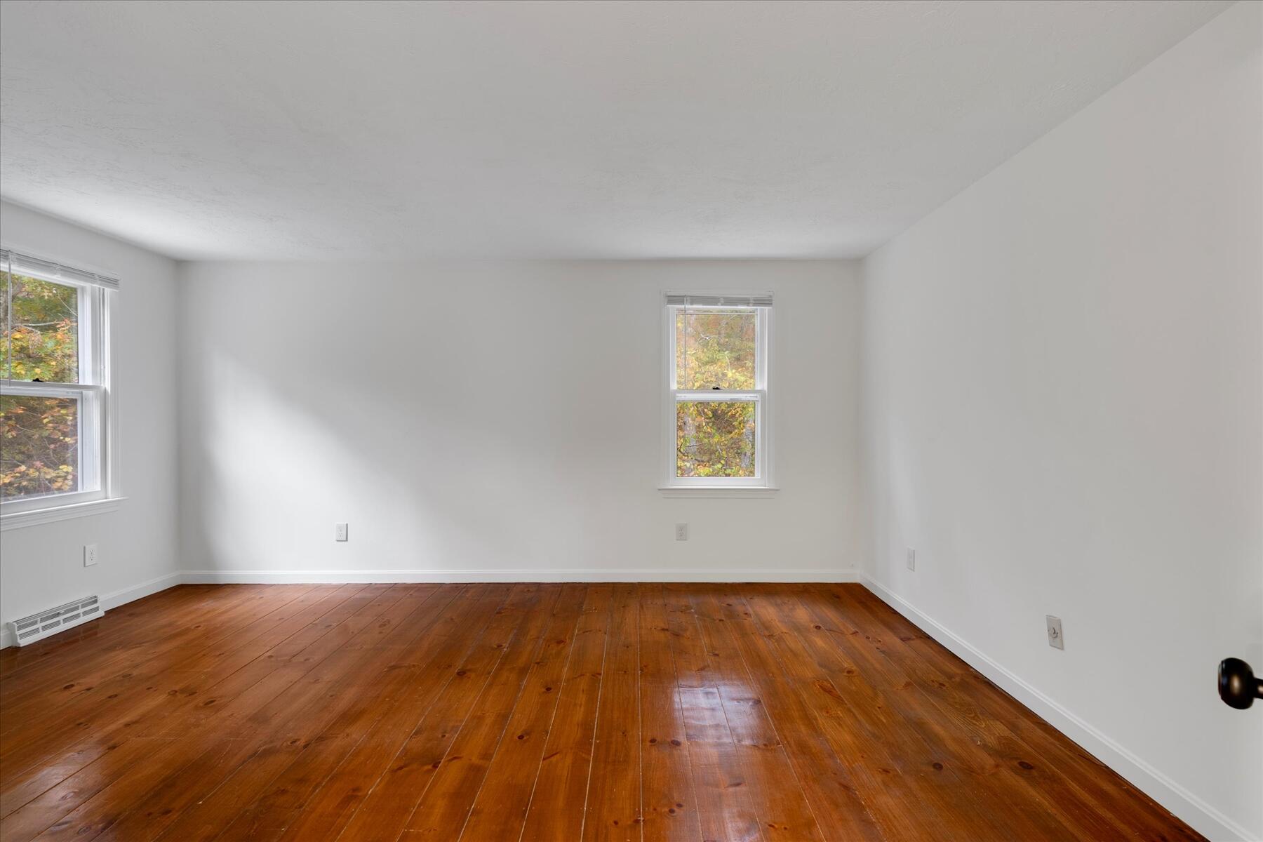 515 Cedar Street West Barnstable, MA 02668 - Photo 18 of 26 an empty room with wooden floor and windows