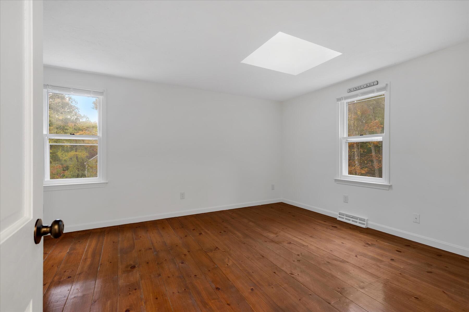 515 Cedar Street West Barnstable, MA 02668 - Photo 21 of 26 a view of an empty room with wooden floor and a window