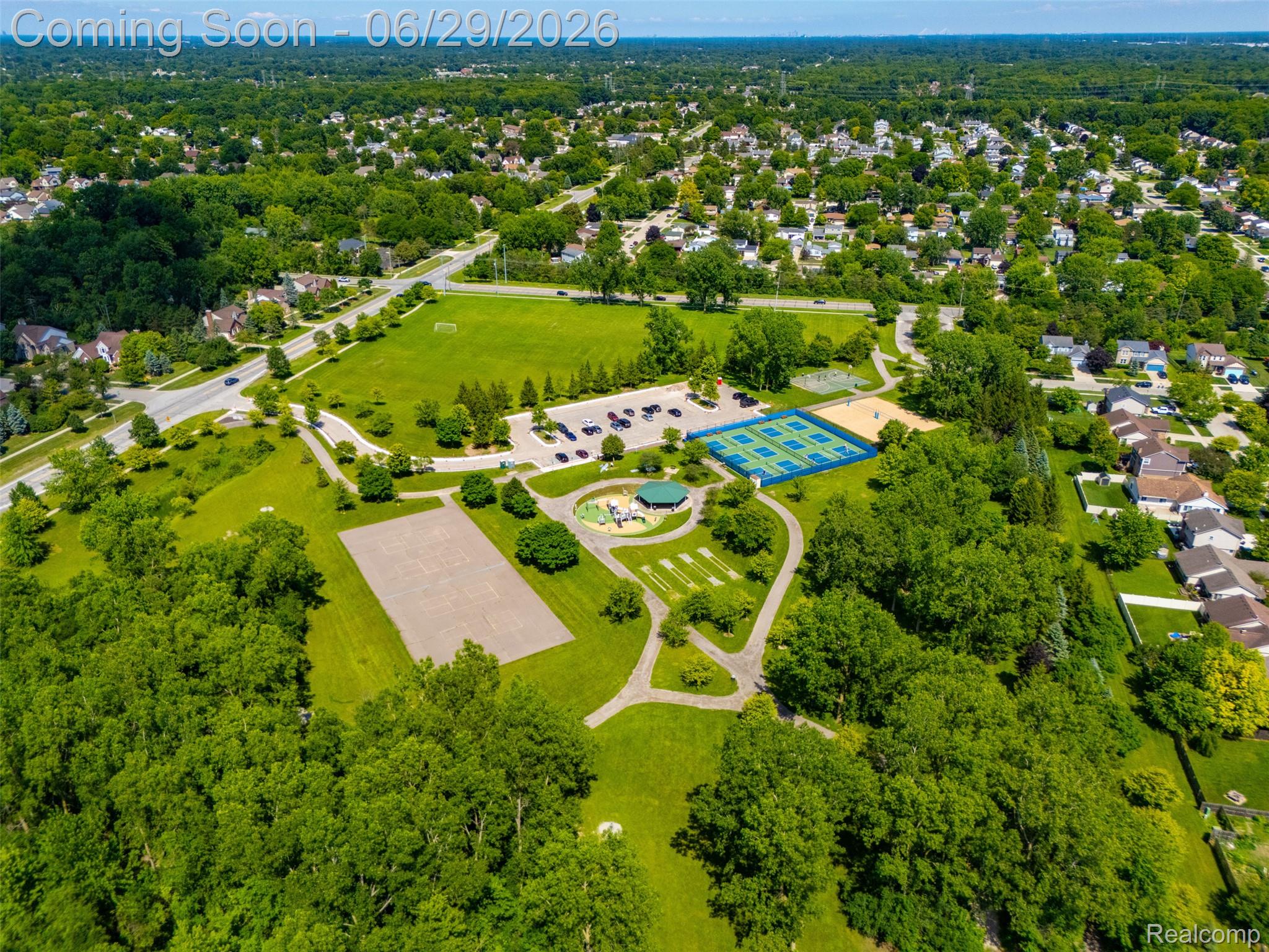 45179 Rudgate Road Canton, MI 48188 - Photo 42 of 48 Expansive neighborhood park featuring multiple sports courts, open green spaces, mature tree coverage, paved walking paths, and a dedicated parking area