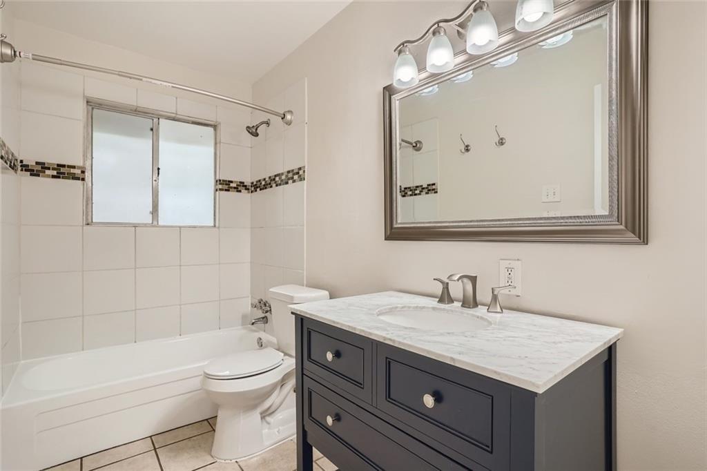 2101 Wheless Lane, Unit A Austin, TX 78723 - Photo 8 of 11 Full bathroom with vanity, shower / bathtub combination, and light tile patterned flooring