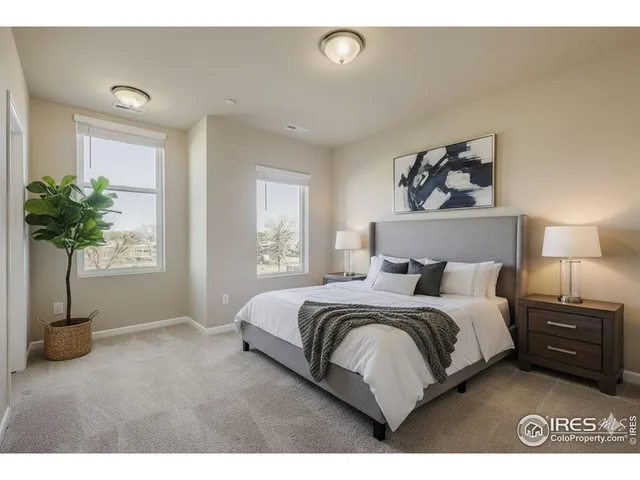 a bedroom with a bed and a potted plant