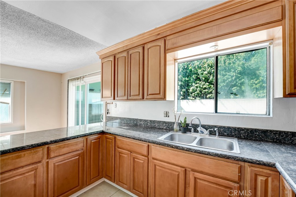 21801 Foley Avenue Carson, CA 90745 - Photo 4 of 10 a kitchen with granite countertop a sink and a window
