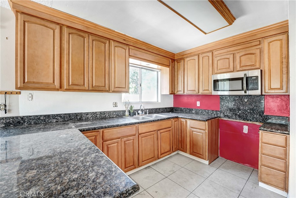 21801 Foley Avenue Carson, CA 90745 - Photo 5 of 10 a kitchen with stainless steel appliances granite countertop a stove sink and cabinets