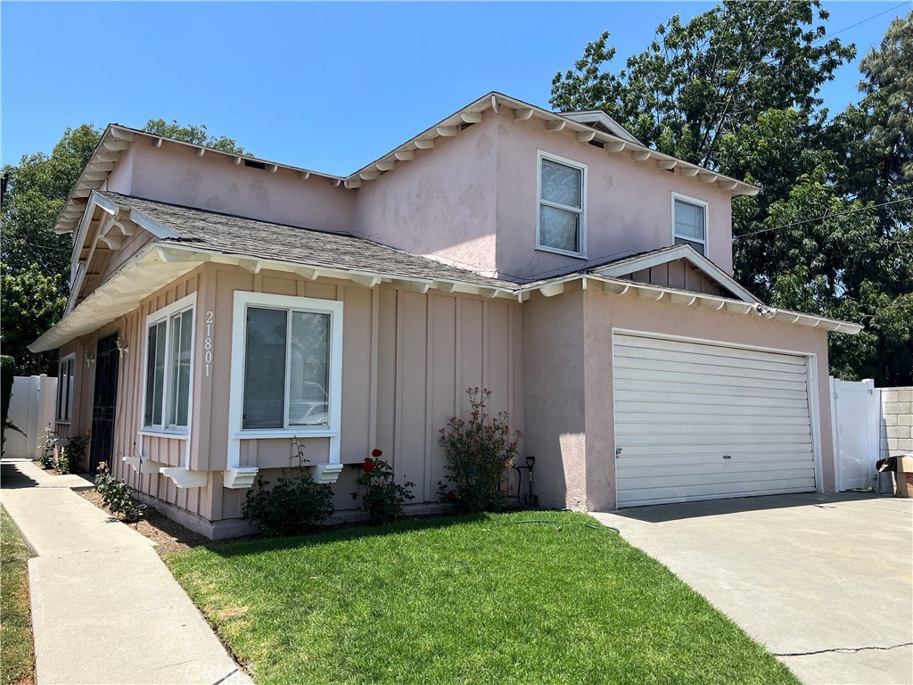 21801 Foley Avenue Carson, CA 90745 - Photo 9 of 10 a front view of a house with a yard and garage