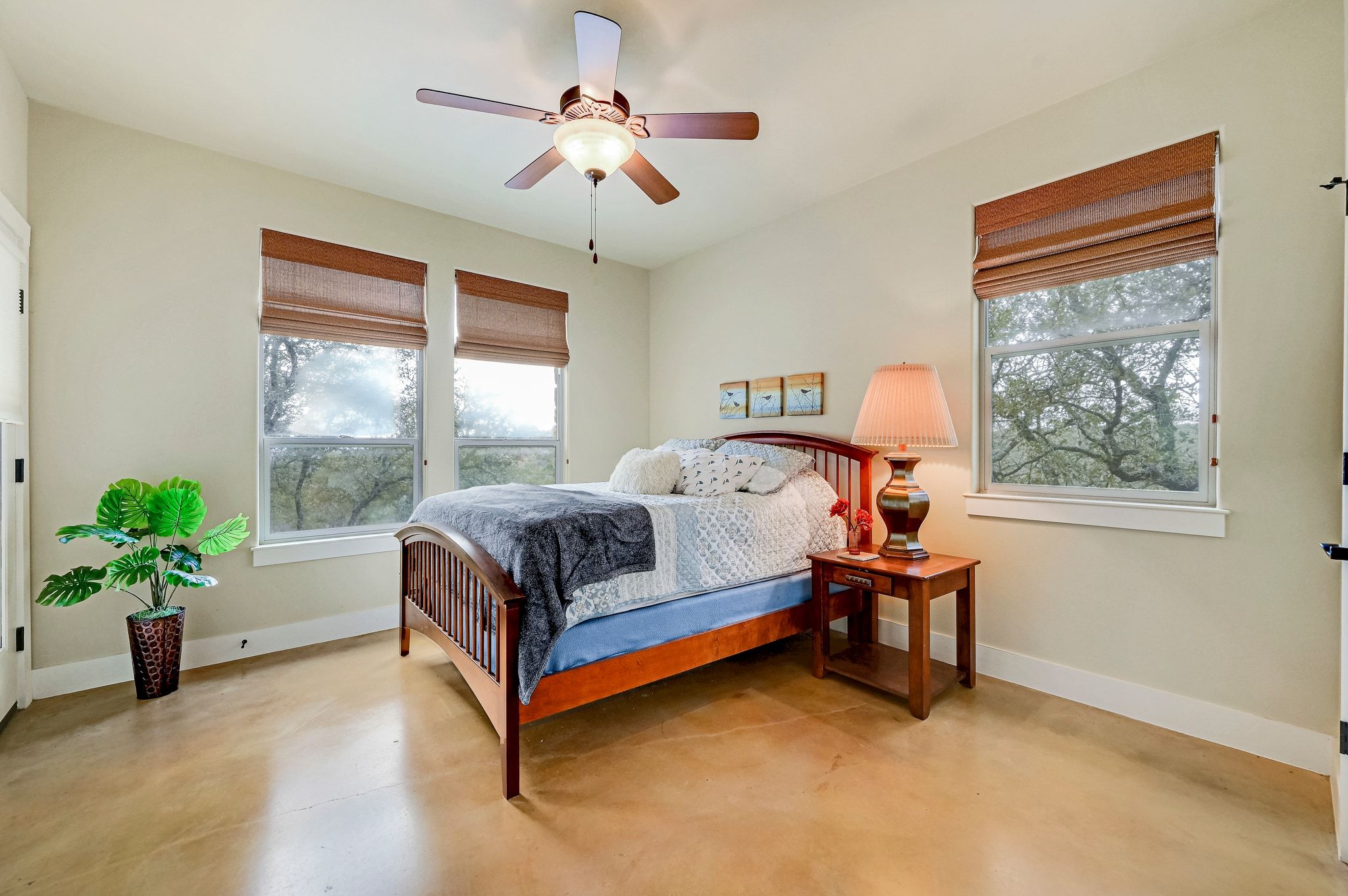 2551 Wolf Creek Ranch Road Burnet, TX 78611 - Photo 11 of 40 Bedroom featuring concrete flooring and a ceiling fan