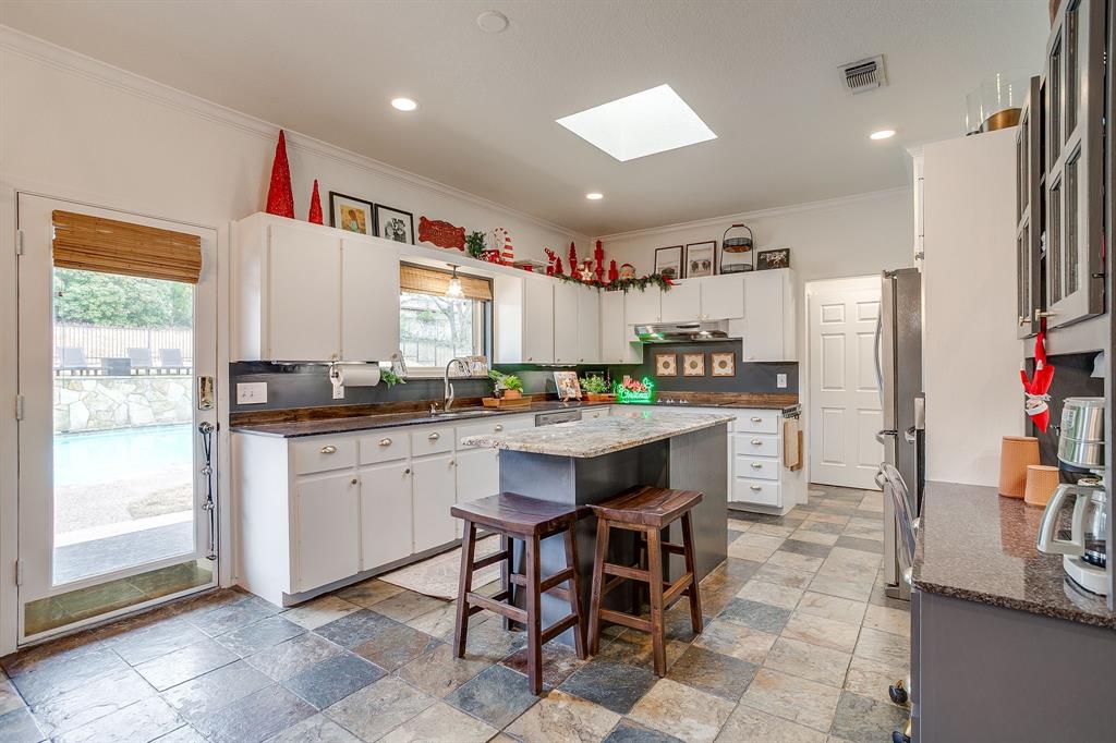 1930 Bethel Road Weatherford, TX 76086 - Photo 13 of 33 a kitchen with stainless steel appliances kitchen island granite countertop a refrigerator and a sink
