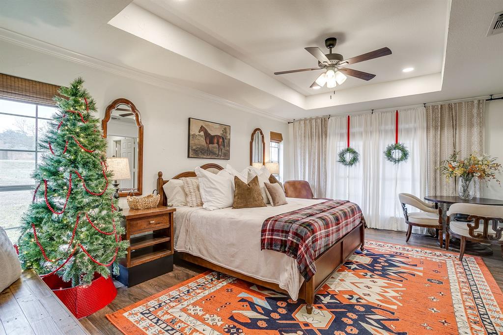 1930 Bethel Road Weatherford, TX 76086 - Photo 15 of 33 a bedroom with a bed and a chandelier